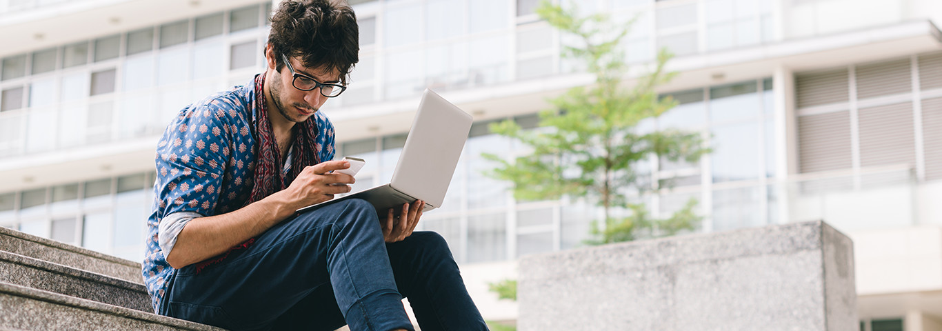 young_man_laptop_cellphone_209647996_0_1