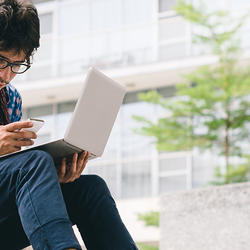 young_man_laptop_cellphone_209647996_0_1
